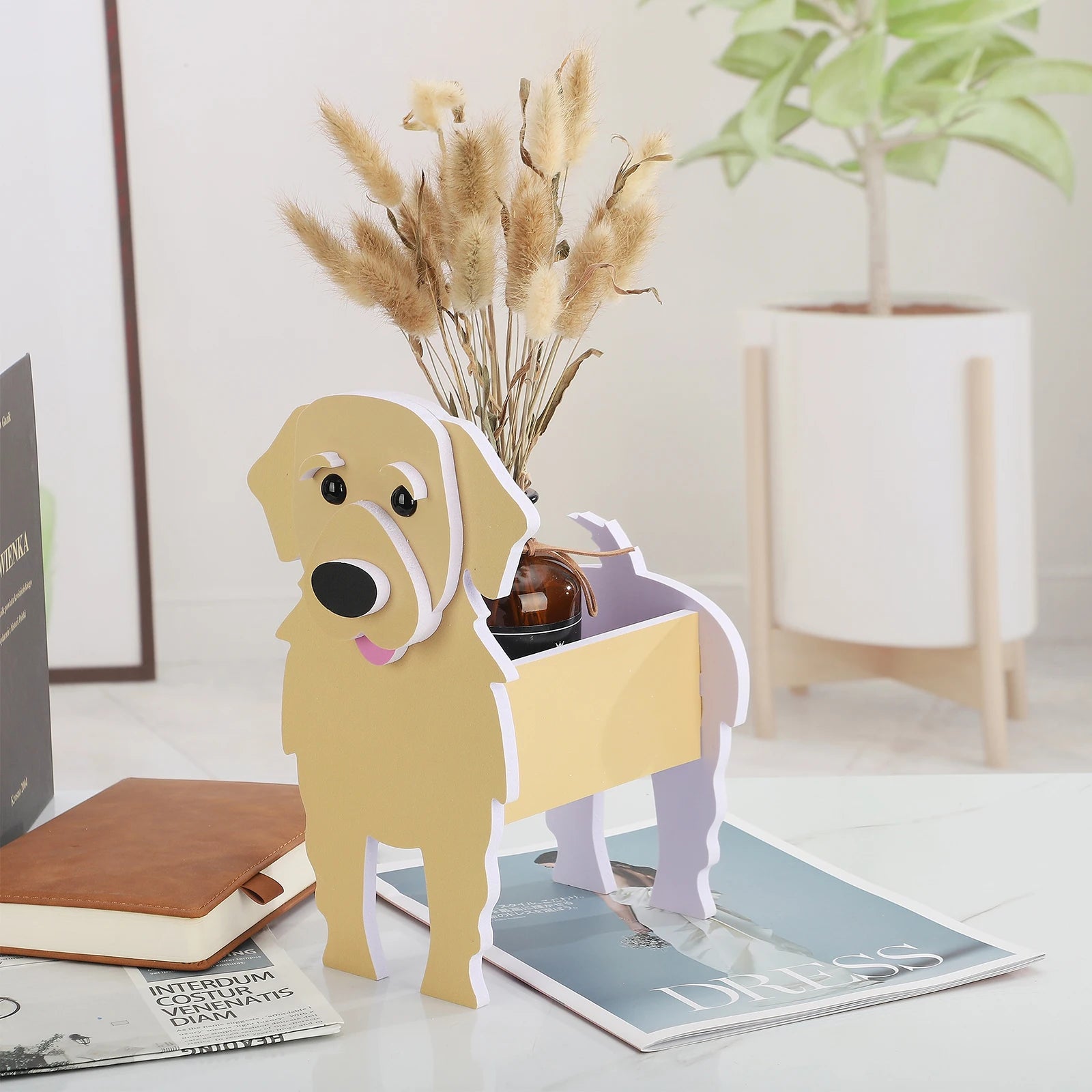 yellow dog shaped planter on desk with dried flowers inside