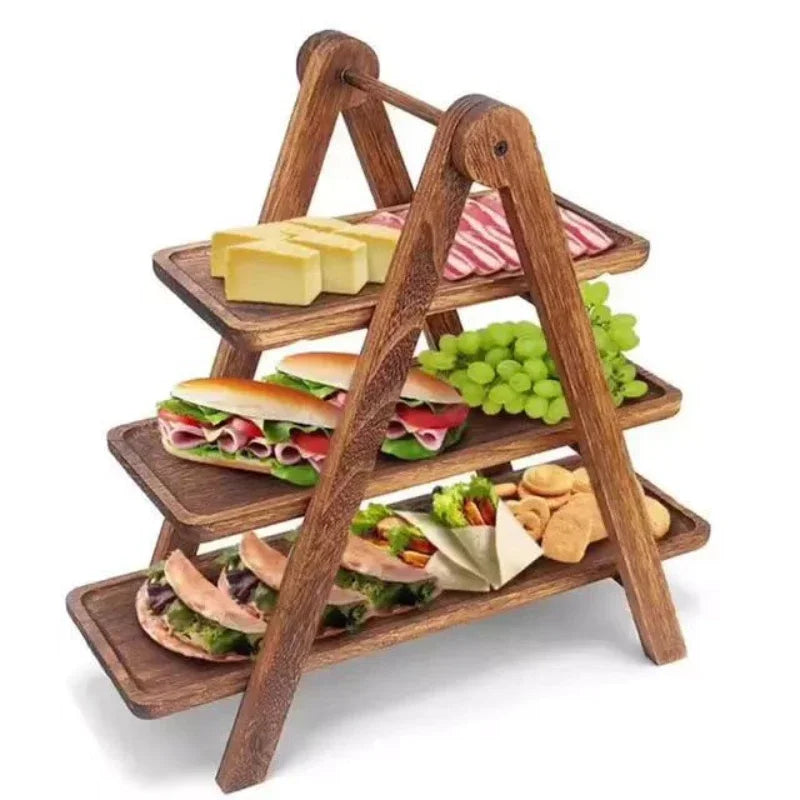 Three-tier wooden serving tray stand with food displayed on each level