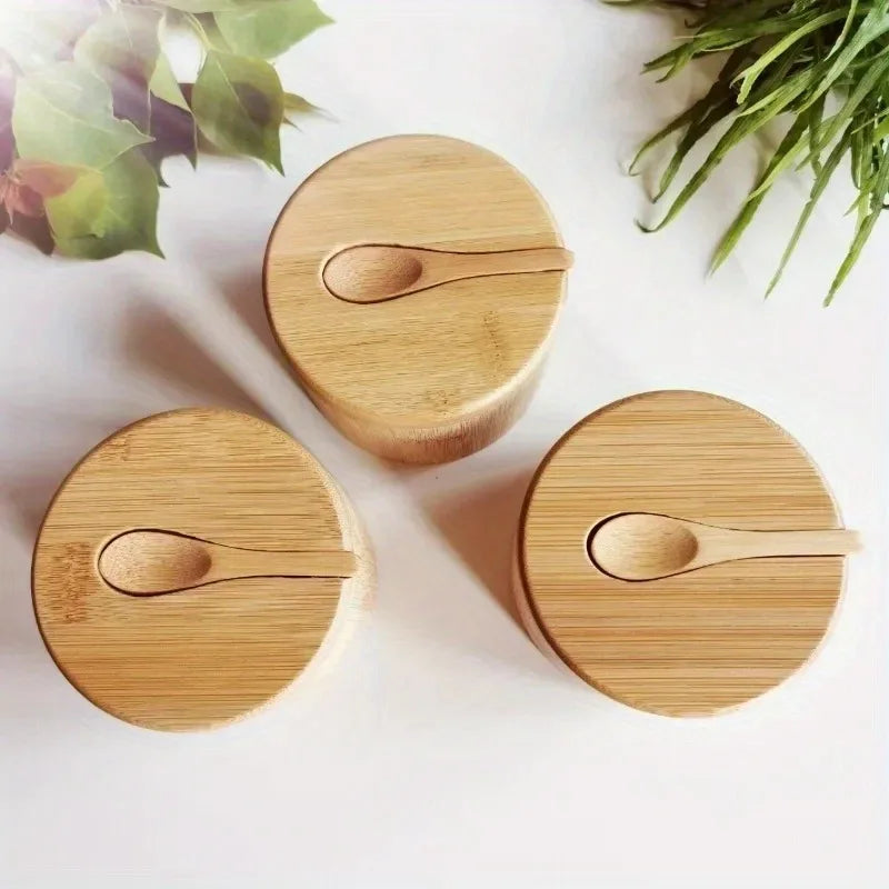 Set of round bamboo spice containers with lids and small spoons on top