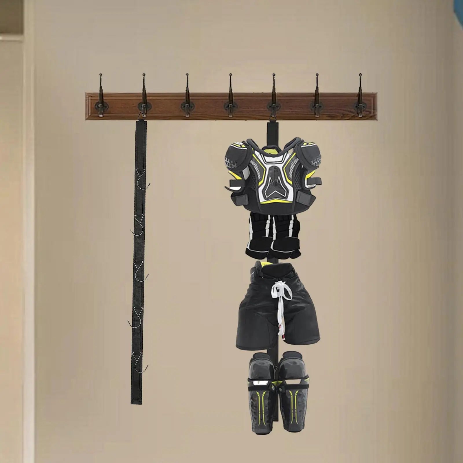 Sports gear hanging vertically on drying rack in a mudroom
