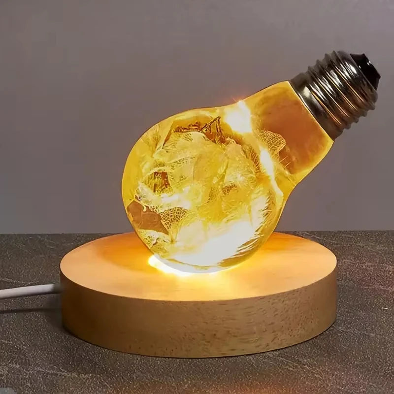 Wooden LED base lighting up an art bulb ornament on a tabletop