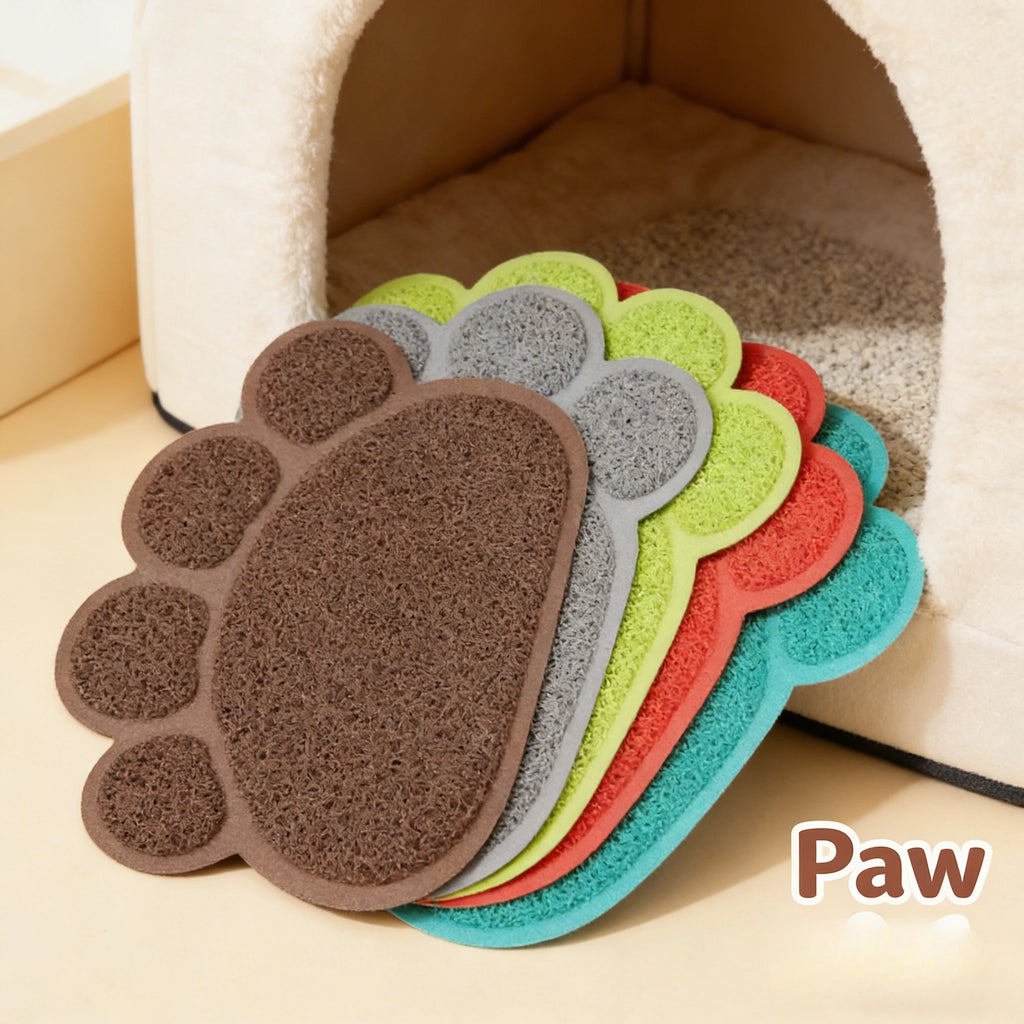 Brown, grey, green, and blue paw print cat mats stacked near a pet house