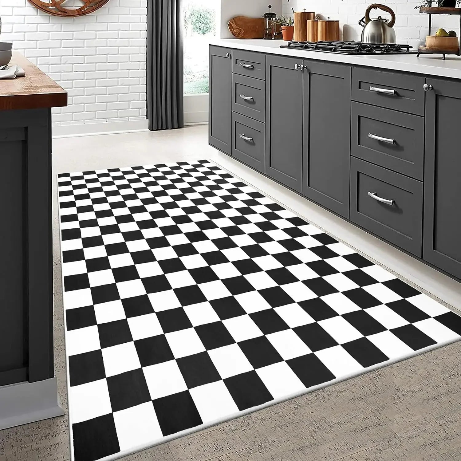 Black and white checkered rug in a modern kitchen with gray cabinets