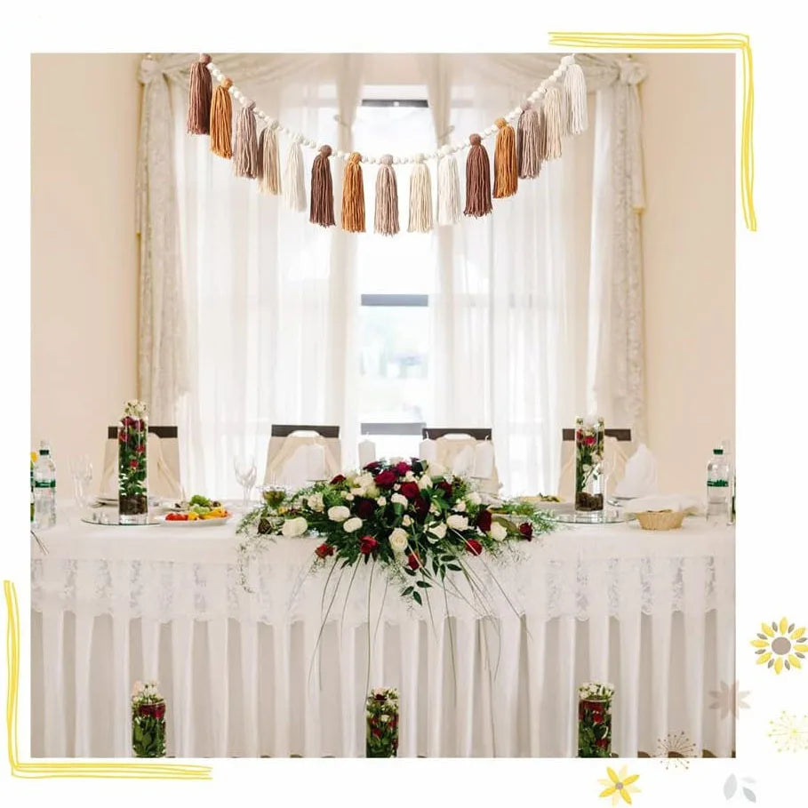 boho tassel garland strung above a decorated party or dining table