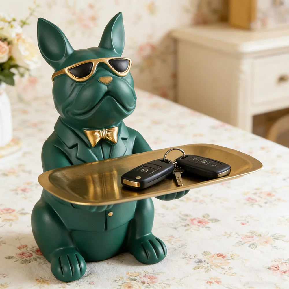 Green resin bulldog decorative tray with keys displayed on a floral table