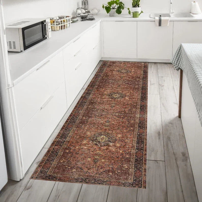 boho vintage style runner rug in a white kitchen on wood-look tile floor