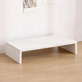 White U-shaped wooden monitor riser stand displayed on a light wood floor.