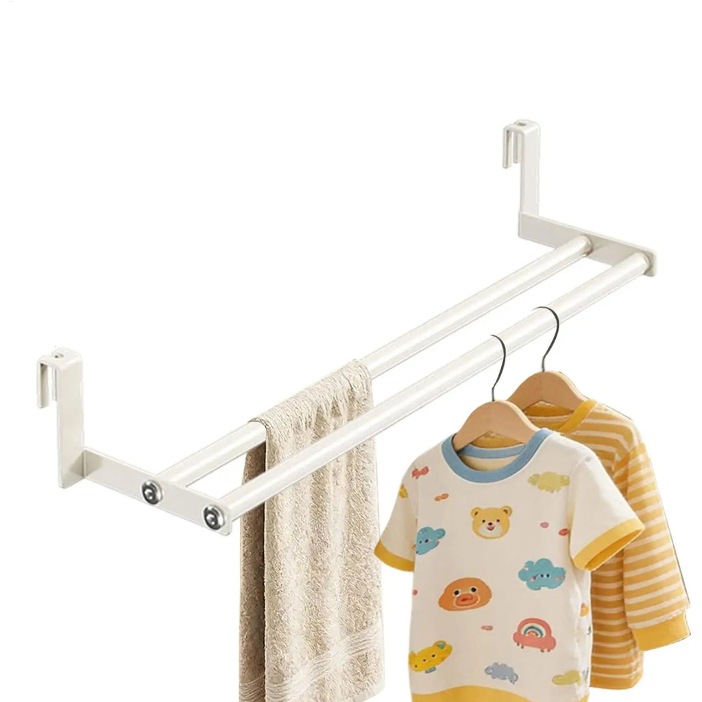 White metal wall-mounted drying rack holding towel and two children's shirts on hangers
