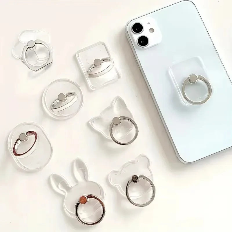 A variety of transparent animal-shaped phone ring holders displayed with a smartphone