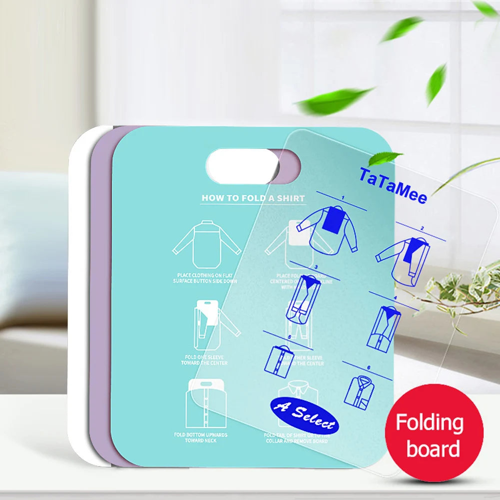 Stack of laundry folding boards in different colors, including one transparent board labeled 'Folding board', in a home setting