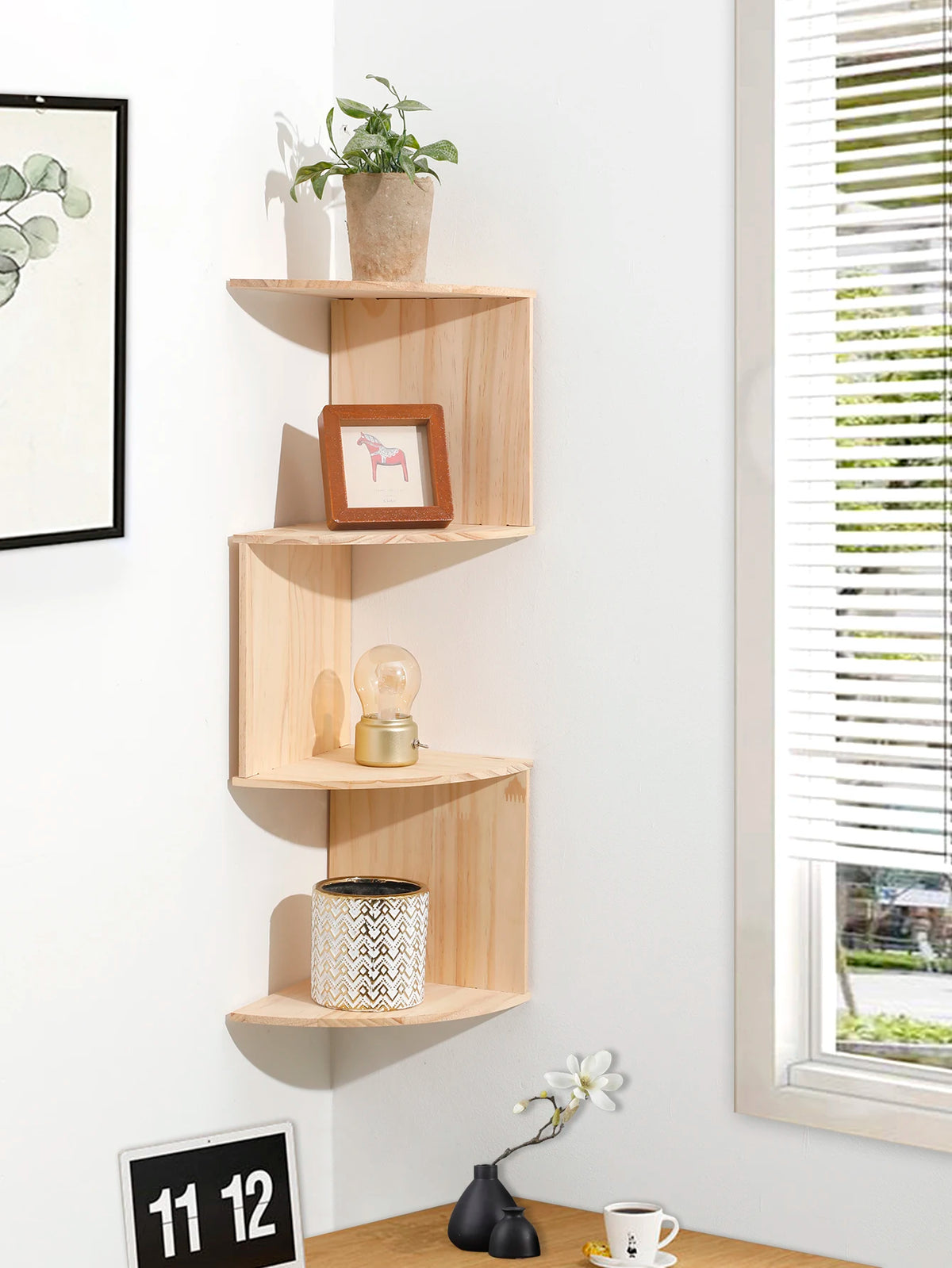 5-tier light wood corner floating shelf displaying decor on a wall by a desk