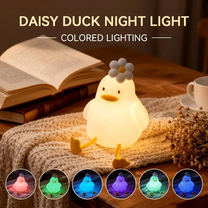 Duck night light on a knitted mat, showing colored lighting options below