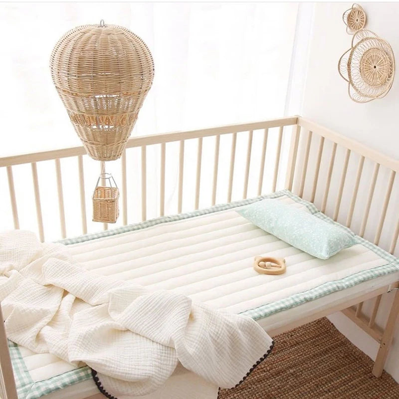 rattan hot air balloon wall hanging above baby crib in nursery