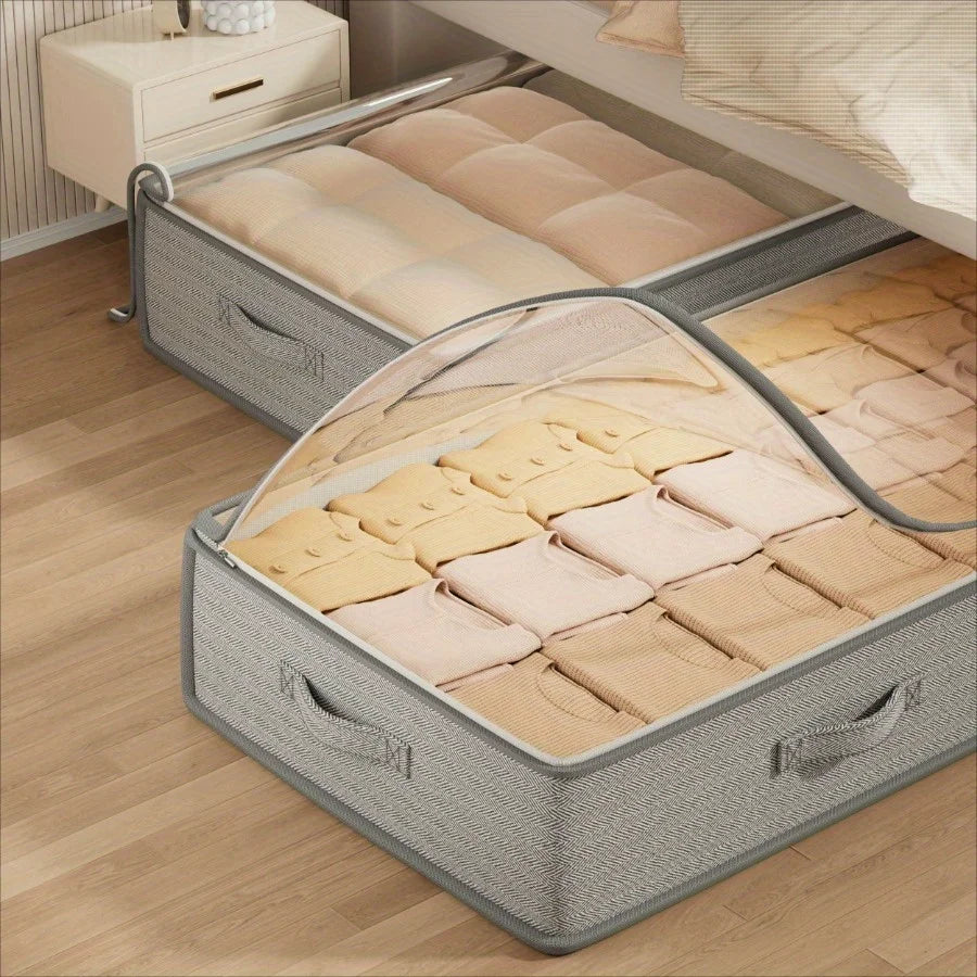 Foldable under-bed storage bins in use, one with a transparent zippered lid partially open, revealing folded knits inside