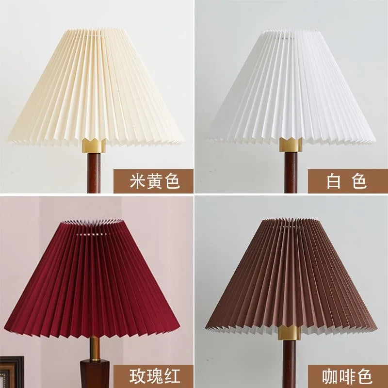 Collage of four cone-shaped pleated fabric lampshades in ivory, white, red, and brown