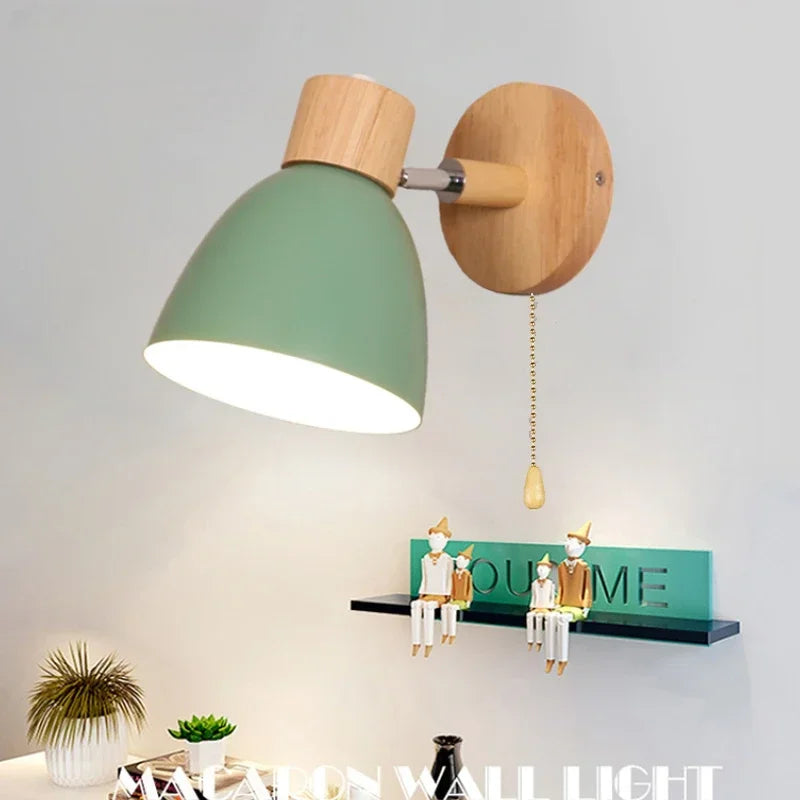green painted iron and wood wall sconce mounted above a shelf in a living room