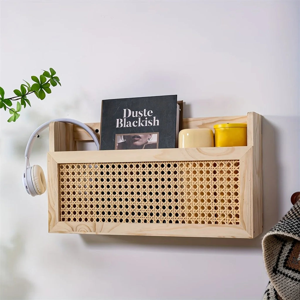 Wooden magazine holder with rattan detail mounted on white wall, styled with book, jars, and headphone
