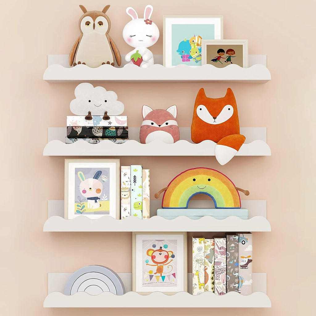 White wavy wooden floating shelves styled in a nursery with plush toys, books, and framed prints
