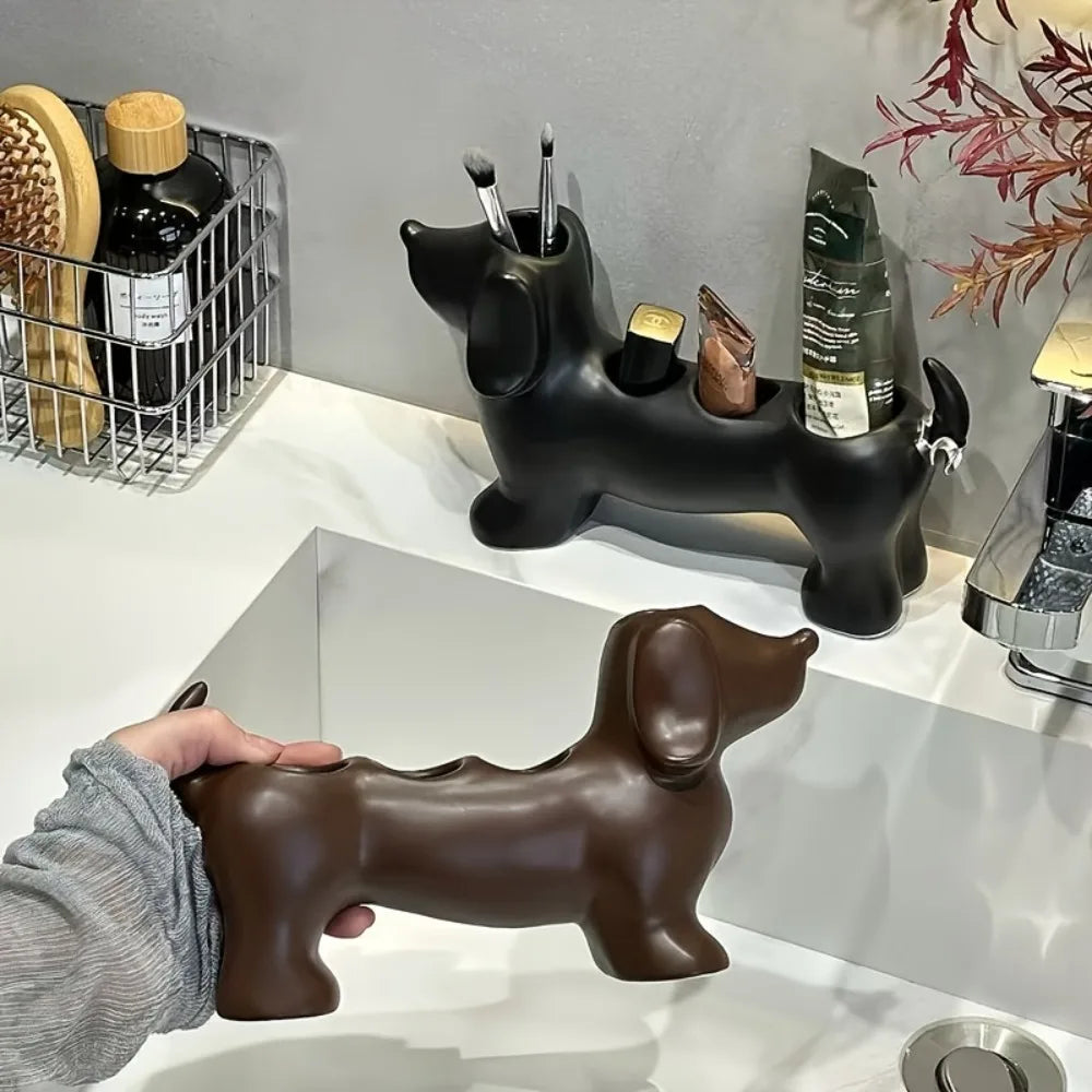Dachshund-shaped plastic holder in black used as a toothbrush organizer on a bathroom counter alongside another in brown