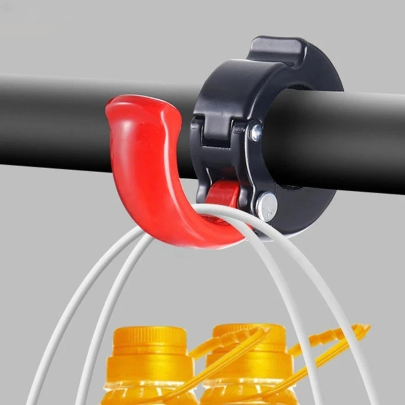 Red hook mounted to bicycle handlebar, carrying shopping bags