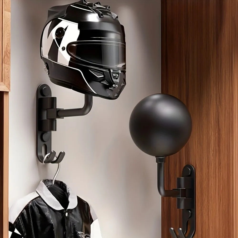 wall-mounted black helmet and hat holder with rotating arm and utility hooks, holding motorcycle helmet and jacket in hallway