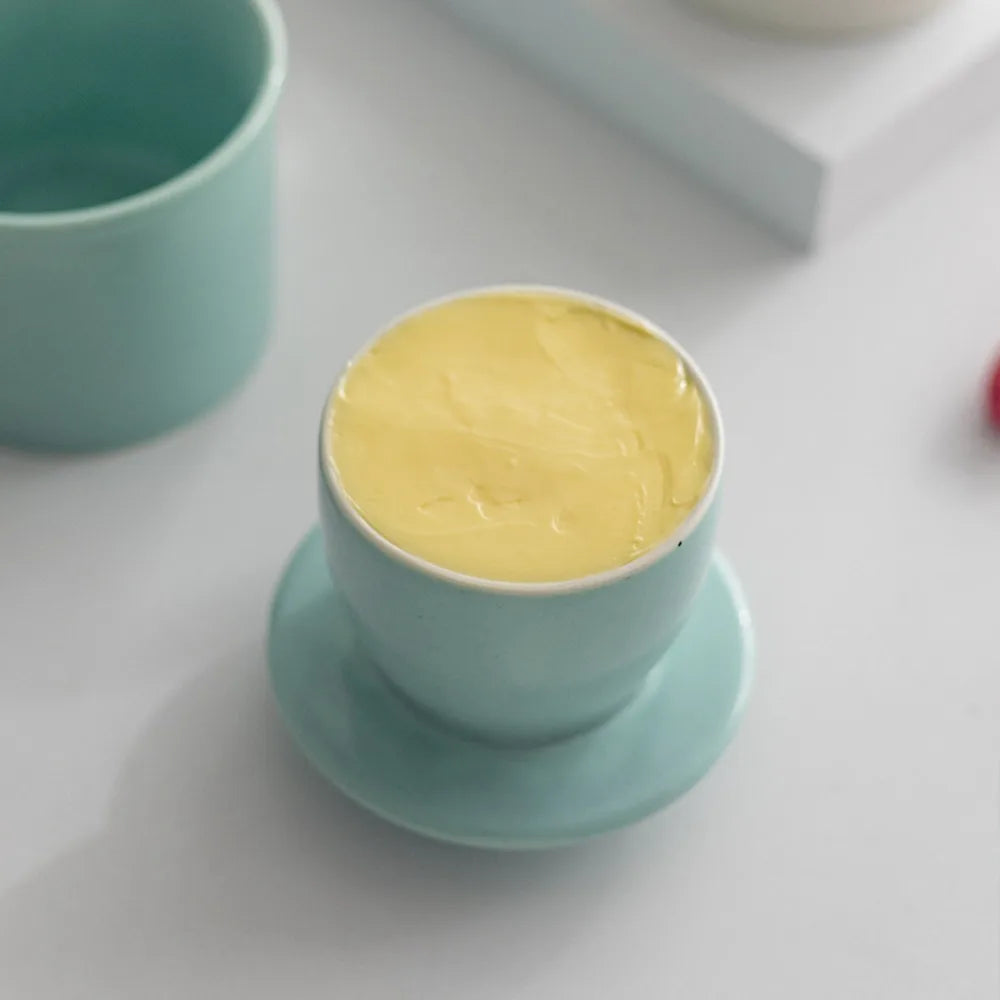 Close-up of light blue French butter crock filled with butter