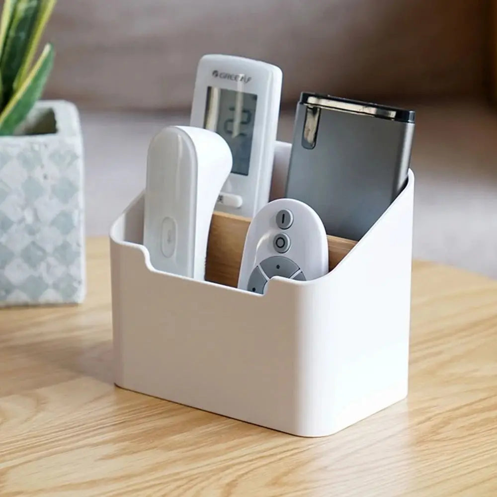 white remote control organizer box holding remotes and small electronics on a coffee table