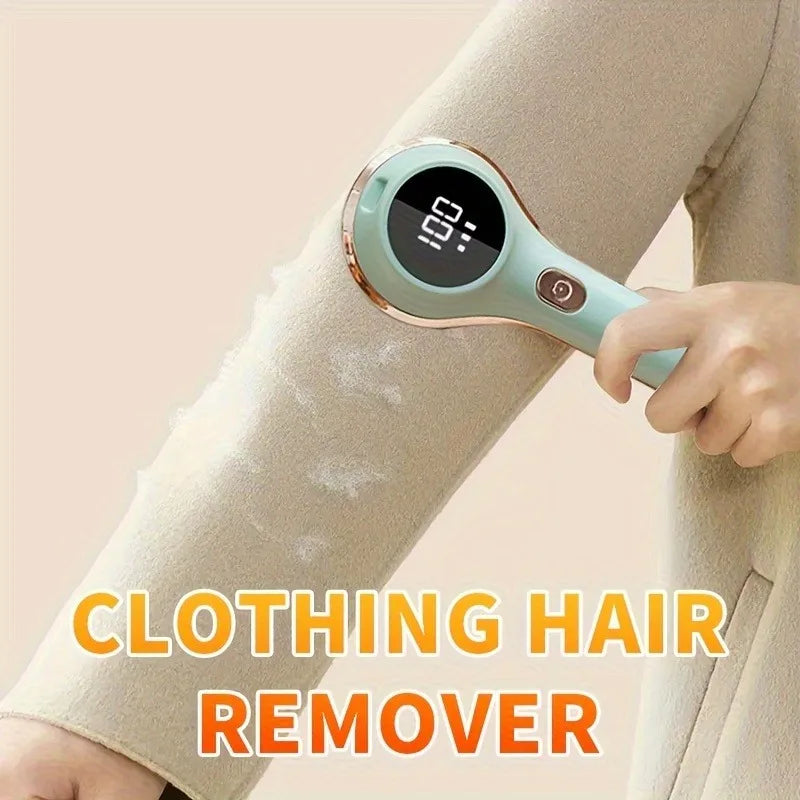 Hand using electric lint remover to remove fuzz from a coat sleeve