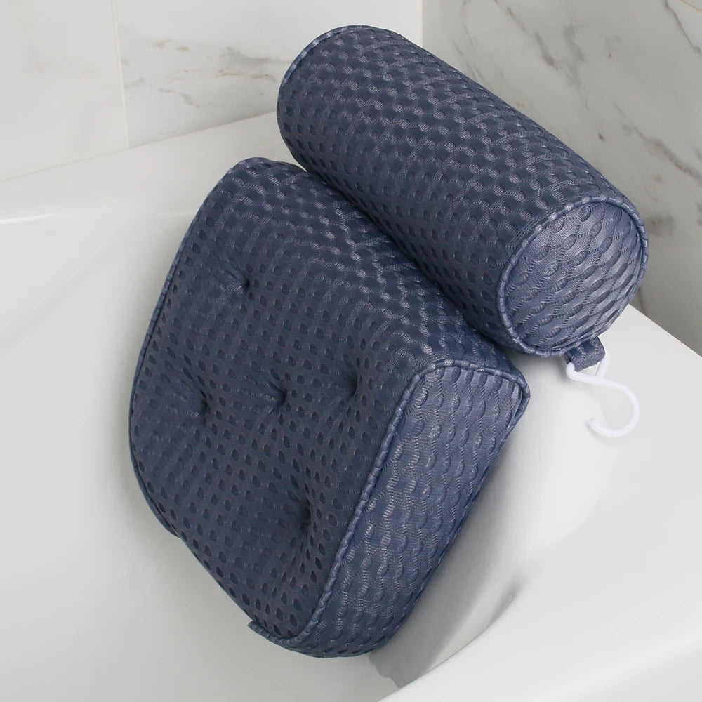 dark blue air mesh bath pillow with neck and back support placed on a white tub in a bathroom