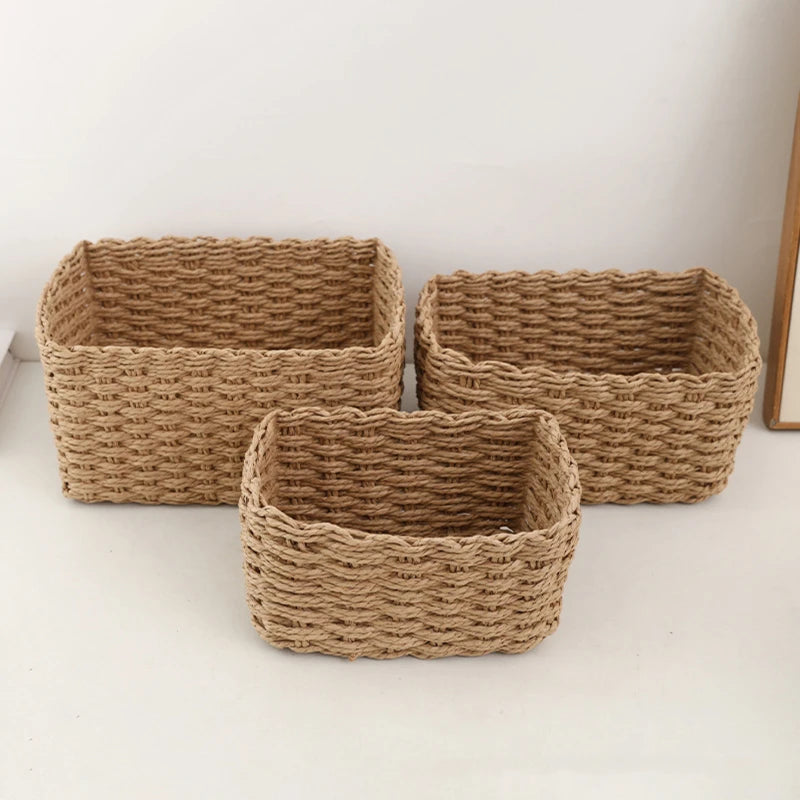Group of three beige handwoven storage baskets arranged on a tabletop