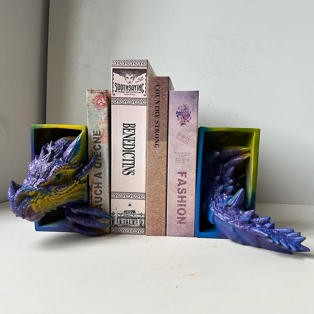 Multicolor dragon head and tail resin bookends holding books on a shelf