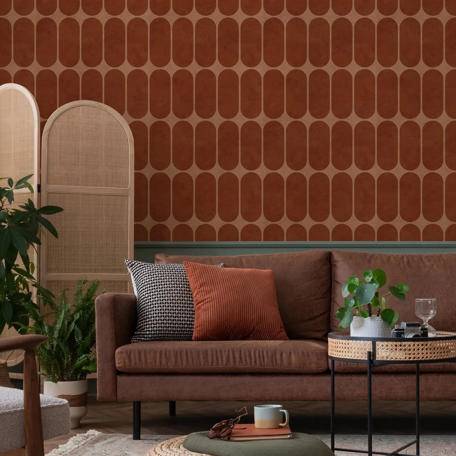 Mid-century arch motif terracotta wallpaper in a living room setting with brown sofa