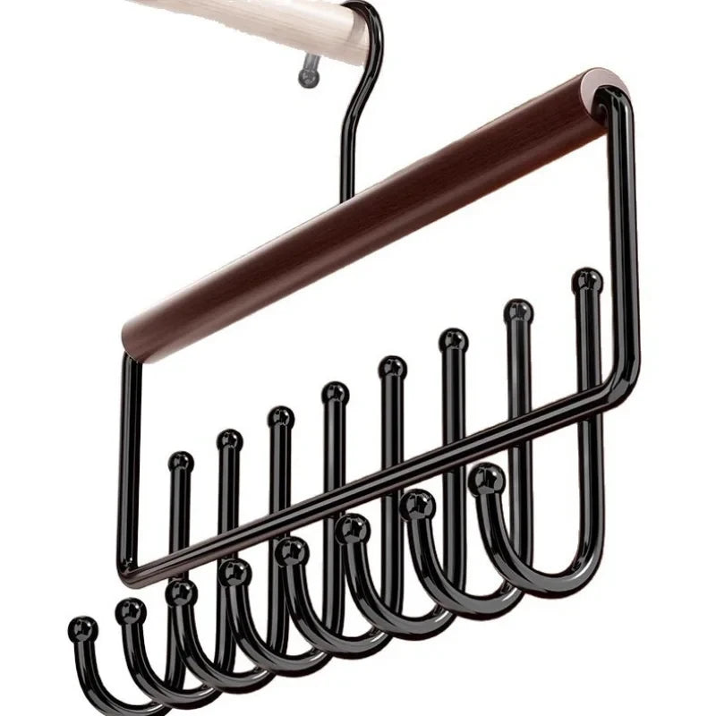Close-up of wooden hat organizer rack showing multiple curved metal hooks and a wood bar