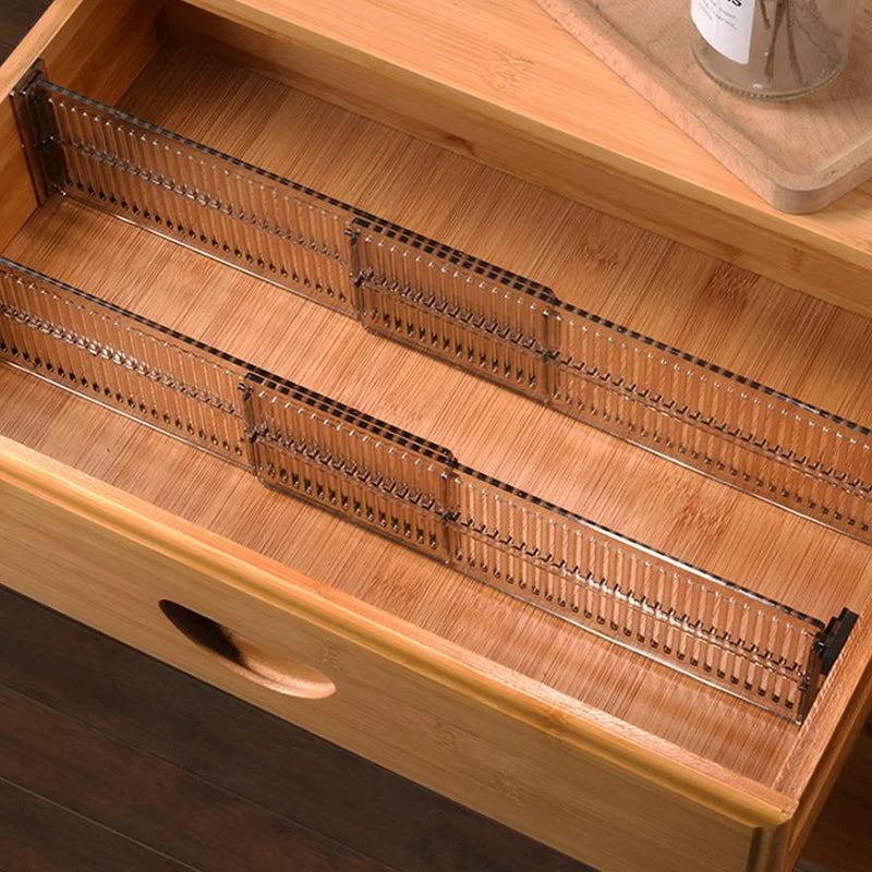 Two clear adjustable drawer dividers organizing a bamboo drawer
