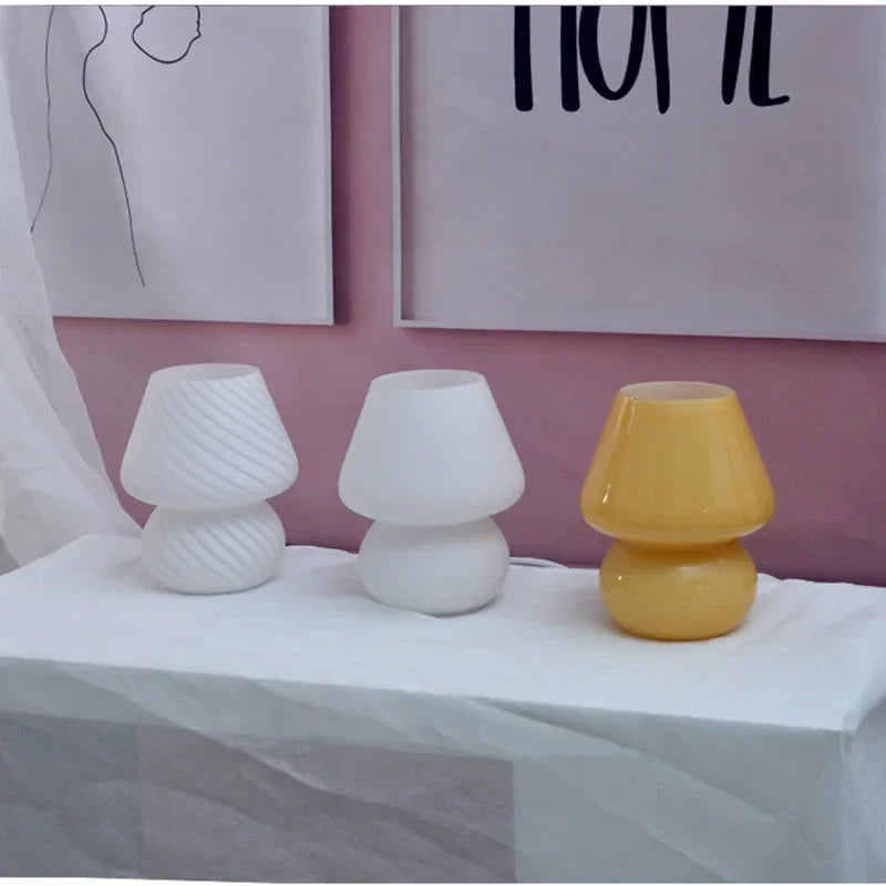Three glass mushroom table lamps in different colors and textures displayed together