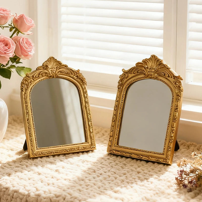 Pair of gold arched tabletop mirrors on a cozy windowsill with pink roses