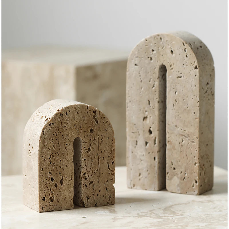 Detail view of large and small travertine stone bookends with matte finish and unique veining