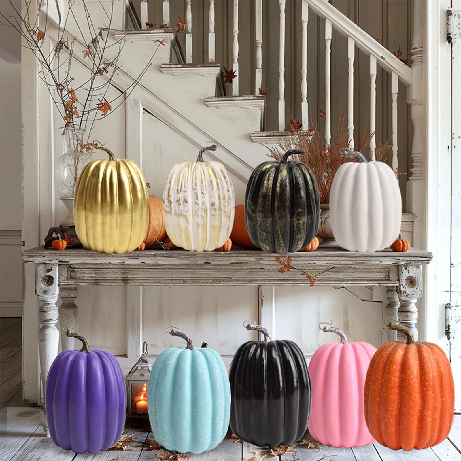 Assorted faux pumpkins in various colors displayed on a white entryway table and stairway for fall decor