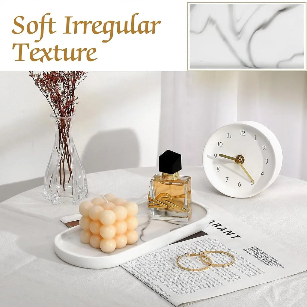Matte oval silicone vanity tray displayed on a table with candles, perfume, and a clock; text highlights soft irregular texture