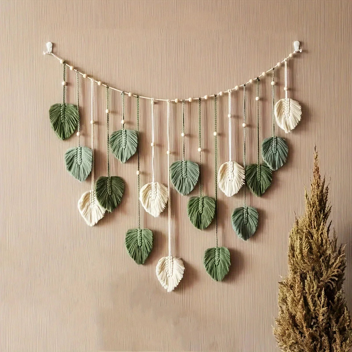 boho green leaf wall hanging in a cozy living room setting