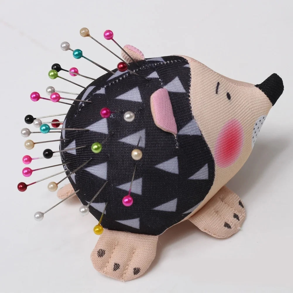 Side view of fabric hedgehog pin cushion holding pins