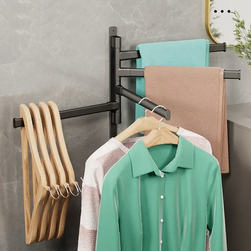 Rotating towel rack in black used for towels and wooden hangers with shirts