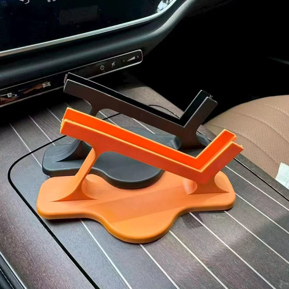 Black and orange plastic phone stands stacked on car console table