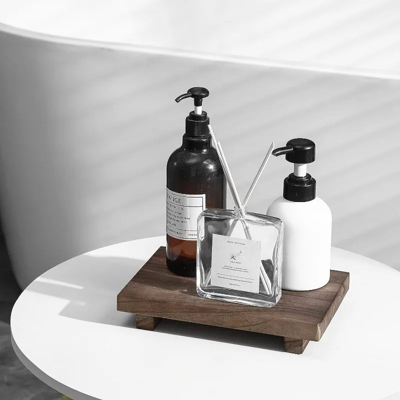 Wooden bathroom riser tray displayed with soap and lotion bottles on a round surface