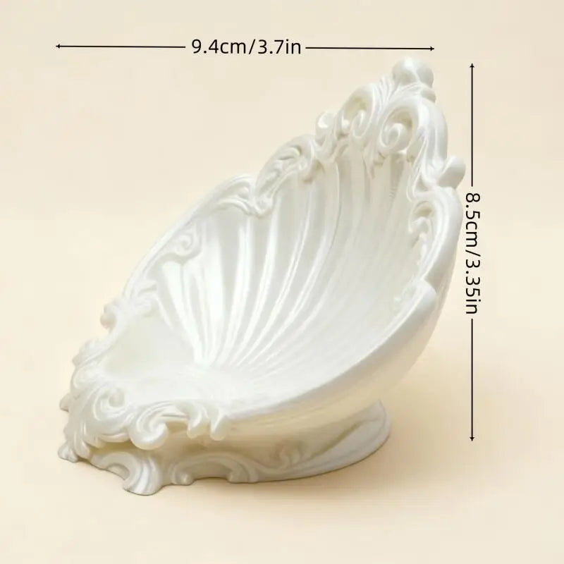 White shell shaped embossed jewelry tray with dimensions 9.4cm by 8.5cm displayed