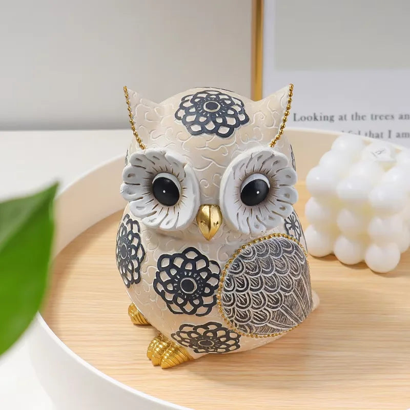 overhead view of owl sculpture on a wooden tray beside decor accents