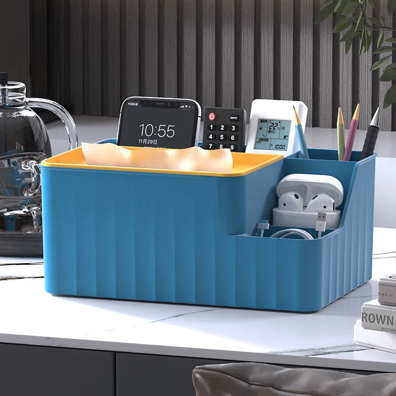 Blue and yellow 6-section organizer with tissue box, remotes, and phone on a white countertop.