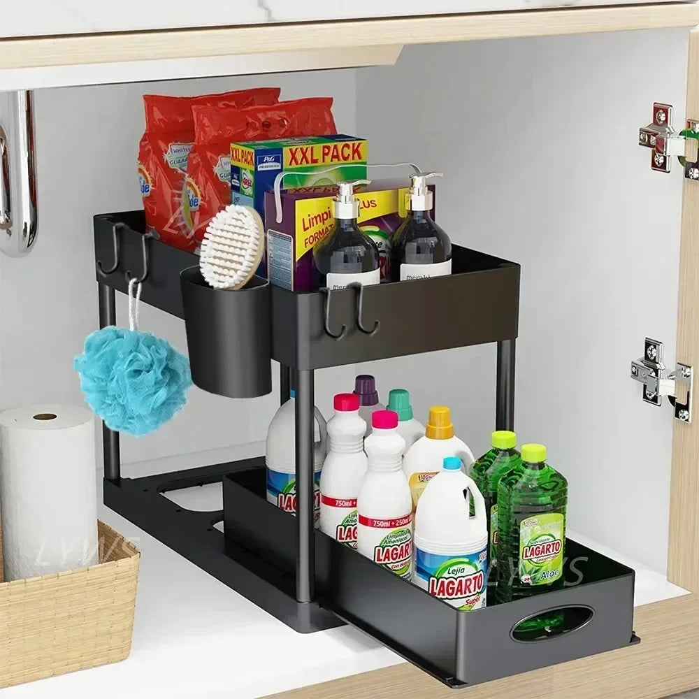 Black two-tier pull-out cabinet organizer installed under a kitchen sink, holding cleaning supplies