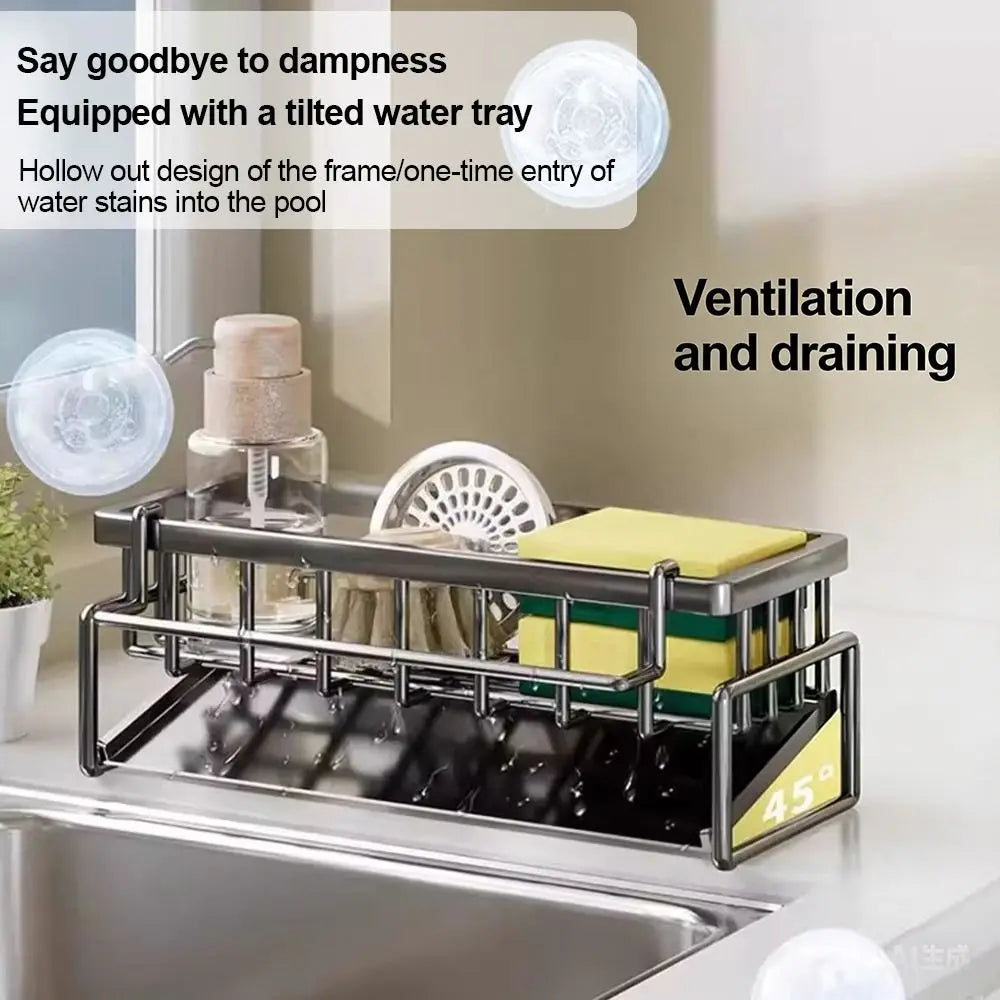 stainless steel sink drying rack with tilted drainage tray and hollow frame for ventilation, holding kitchen sponges and cleaning tools on a countertop