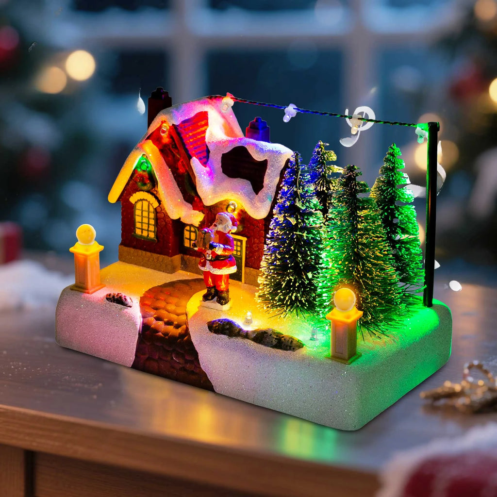 Close-up of battery operated Christmas village scene with lit house, Santa, and colorful trees